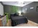 A bedroom with dark walls, an ivy wall hanging and neutral colored carpet at 260 Ingonish Dr, Gastonia, NC 28056