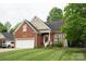 Beautifully landscaped brick home with an attached two-car garage and inviting entryway at 260 Ingonish Dr, Gastonia, NC 28056