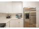 Bright kitchen features stainless steel refrigerator, white cabinets, and quartz countertops at 260 Ingonish Dr, Gastonia, NC 28056