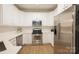 Well-equipped kitchen with stainless steel appliances, white cabinetry and tiled backsplash at 260 Ingonish Dr, Gastonia, NC 28056