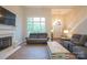 Inviting living room with hardwood floors, a decorative fireplace, and a large window at 260 Ingonish Dr, Gastonia, NC 28056