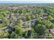Aerial view showcasing the home's location within a tree-filled residential area with cityscape visible in the distance at 261 8Th Avenue Se Dr, Hickory, NC 28602