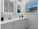 Bathroom with double sink vanity, lighted mirrors and modern fixtures at 261 8Th Avenue Se Dr, Hickory, NC 28602