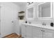 Bathroom featuring a double sink vanity with modern lighting and floating shelves at 261 8Th Avenue Se Dr, Hickory, NC 28602
