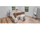 Bedroom featuring light-filled windows, decorative pillows, and a wood floor at 261 8Th Avenue Se Dr, Hickory, NC 28602