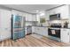 Modern kitchen with white cabinets, stainless steel appliances, and stylish backsplash, offering ample counter space at 261 8Th Avenue Se Dr, Hickory, NC 28602