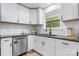 Bright kitchen featuring white cabinetry, stainless steel appliances, and dark countertops, with natural light at 261 8Th Avenue Se Dr, Hickory, NC 28602