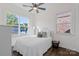 Bright bedroom featuring large windows, hardwood floors, ceiling fan and stylish furnishings at 3012 Laney Pond Rd, Matthews, NC 28104