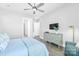 Comfortable bedroom with wood floors, ceiling fan, sitting area, and light-colored walls at 3012 Laney Pond Rd, Matthews, NC 28104