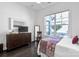 Bedroom with hardwood floors, stylish decor, bright natural light, and large window at 3012 Laney Pond Rd, Matthews, NC 28104