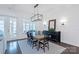 Elegant dining room featuring a wooden table with seating for six, with modern lighting and decor at 3012 Laney Pond Rd, Matthews, NC 28104