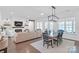 Bright dining room with modern lighting, table with seating for six, and white walls at 3012 Laney Pond Rd, Matthews, NC 28104