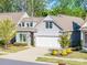 Beautiful single-Gathering home featuring a two-car garage, landscaped yard and stone accents at 3012 Laney Pond Rd, Matthews, NC 28104