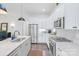 Kitchen with stainless steel appliances, white cabinets, and granite countertops; features updated fixtures at 3012 Laney Pond Rd, Matthews, NC 28104