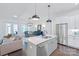 Open kitchen with an island, stainless steel appliances, and seamless flow to the dining and living areas at 3012 Laney Pond Rd, Matthews, NC 28104