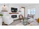 Cozy living room featuring a fireplace with wood mantel, a TV and a comfortable seating area at 3012 Laney Pond Rd, Matthews, NC 28104