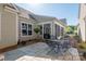 Back patio with seating for four, surrounded by landscaping and view of screen porch at 3012 Laney Pond Rd, Matthews, NC 28104