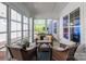 Bright sunroom with comfortable seating and windows providing views of the surrounding landscape at 3012 Laney Pond Rd, Matthews, NC 28104