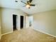 Spacious bedroom with a ceiling fan and neutral carpet at 3129 Brockhampton Ct, Charlotte, NC 28269