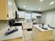White kitchen with stainless appliances, tile floor, and island at 3129 Brockhampton Ct, Charlotte, NC 28269