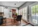 Dining area with wood floors, natural light from the surrounding windows, and a table with seating at 3131 Arborhill Rd, Charlotte, NC 28270