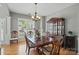 Traditional dining room featuring hardwood floors, a chandelier, and a hutch at 3131 Arborhill Rd, Charlotte, NC 28270