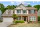 Charming two-story home with manicured lawn, traditional brick, and neutral siding at 3131 Arborhill Rd, Charlotte, NC 28270