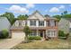 Charming two-story home with manicured lawn, traditional brick, and neutral siding at 3131 Arborhill Rd, Charlotte, NC 28270