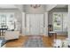 Bright foyer featuring hardwood floors, white trim, and view into living area at 3131 Arborhill Rd, Charlotte, NC 28270