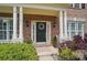 Inviting front entry with black door, classic wreath, and beautiful landscaping at 3131 Arborhill Rd, Charlotte, NC 28270