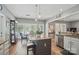 Kitchen with island seating area and granite countertops provides an ideal view of the surrounding dining and living spaces at 3131 Arborhill Rd, Charlotte, NC 28270