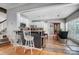 Eat-in kitchen with white cabinetry, stainless appliances, a gray island with seating, and dining area at 3131 Arborhill Rd, Charlotte, NC 28270