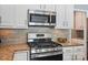 Kitchen with stainless steel range and microwave appliances and beautiful granite counter tops at 3131 Arborhill Rd, Charlotte, NC 28270