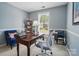 This office features gray walls, natural light from a window and a classic wooden desk and comfortable seating at 3131 Arborhill Rd, Charlotte, NC 28270
