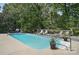 Backyard with a refreshing in-ground pool, sun loungers, and lush greenery for relaxing summer days at 3131 Arborhill Rd, Charlotte, NC 28270