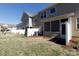 View of the backyard with a screen porch and a white fence at 3246 Yarmouth Ln, Gastonia, NC 28056