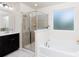 Bright bathroom featuring a glass enclosed shower and soaking tub at 3246 Yarmouth Ln, Gastonia, NC 28056