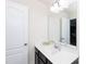 Bright bathroom featuring a dark vanity cabinet, white sink, and a large mirror at 3246 Yarmouth Ln, Gastonia, NC 28056