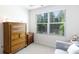 A sunny bedroom with a light grey chair at 3246 Yarmouth Ln, Gastonia, NC 28056