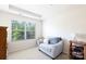 Comfortable bedroom with a chair, side table, and a large window with a peaceful backyard view at 3246 Yarmouth Ln, Gastonia, NC 28056