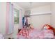 Cozy bedroom featuring a twin bed, window with colorful curtains, and closet space at 3246 Yarmouth Ln, Gastonia, NC 28056