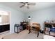 Well-lit room with two desks, shelves, neutral walls and carpet, and a ceiling fan at 3246 Yarmouth Ln, Gastonia, NC 28056