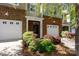 Charming townhome exterior featuring a brick facade, attached garage, and beautiful landscaping with flowering bushes at 3246 Yarmouth Ln, Gastonia, NC 28056