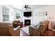 Comfortable living room with a fireplace, plush seating, and natural light at 3246 Yarmouth Ln, Gastonia, NC 28056