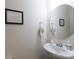 Stylish powder room featuring modern fixtures, a round mirror, and decorative elements at 3246 Yarmouth Ln, Gastonia, NC 28056