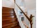 Wooden staircase with white spindles leading to the upper level at 3246 Yarmouth Ln, Gastonia, NC 28056