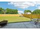 Backyard with privacy fence, green grass, rock garden and patio set at 3335 Hawick Commons Dr, Concord, NC 28027