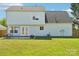 Exterior of home showing the backyard with patio, fire pit, and privacy fence at 3335 Hawick Commons Dr, Concord, NC 28027