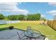 Backyard boasts a privacy fence, rock garden, green grass, and patio set at 3335 Hawick Commons Dr, Concord, NC 28027