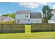 Home's backyard featuring wood privacy fence and lush green grass at 3335 Hawick Commons Dr, Concord, NC 28027